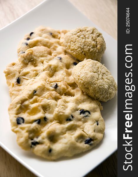 Many kinds of homemade cookies on white plate