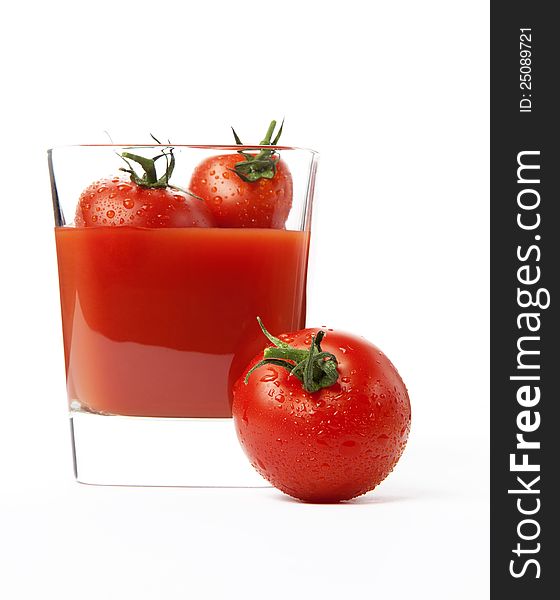 Fresh cherry tomatoes and a glass of tomato juice, isolated on white background