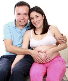 Portrait Of A Happy Young Pregnant Couple Stock Photo