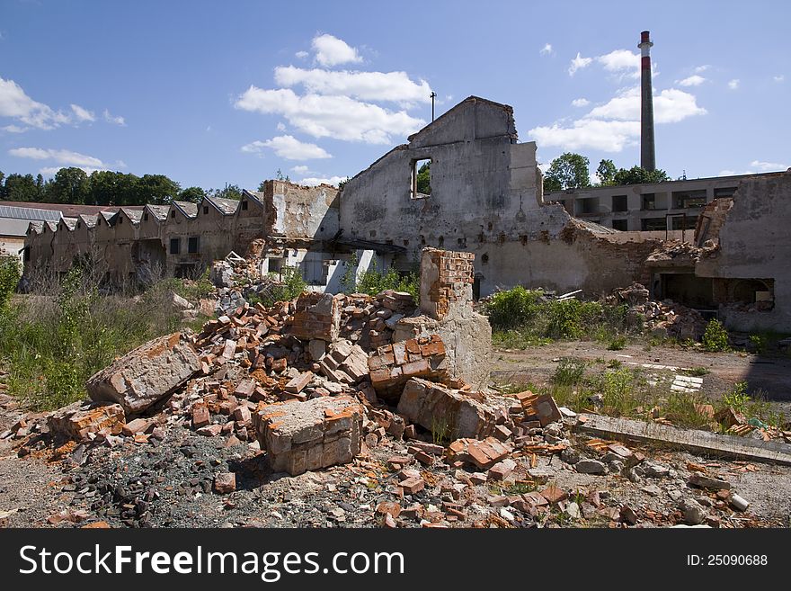 Pile of bricks before the dilapidated building,. Pile of bricks before the dilapidated building,