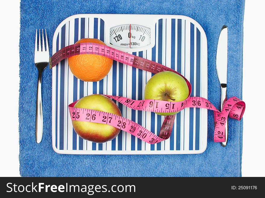 Ideas of healthy lifestyle - weights, measuring tape and fruits