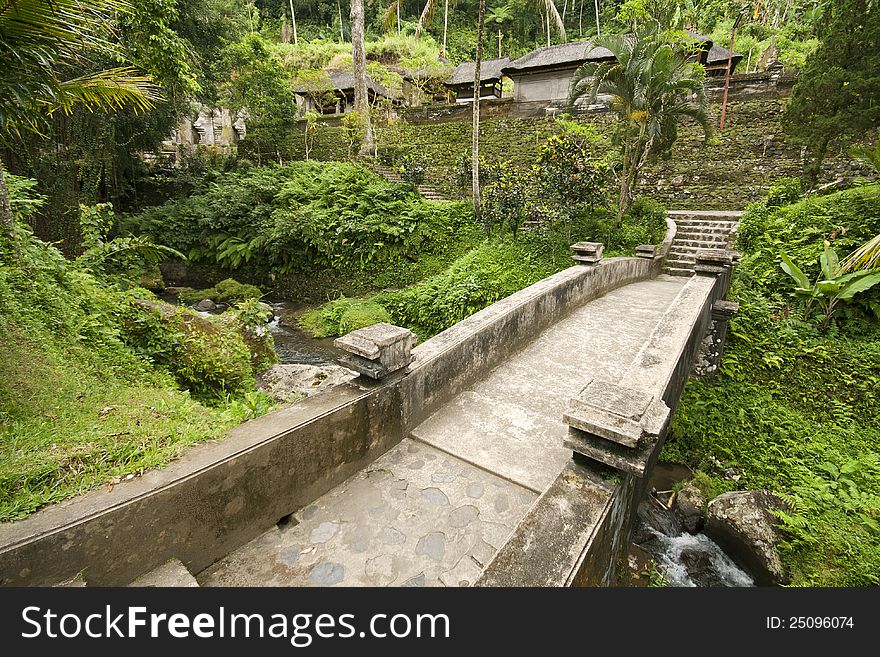 Old stone bridge at Gunung Kawis green and lush environment in Bali.