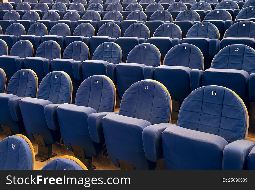 Empty cinema auditorium with lines of blue chairs. Empty cinema auditorium with lines of blue chairs.