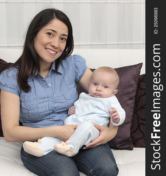 Mother and baby laugh together at home