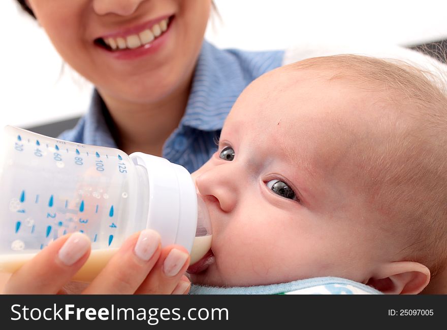 Adorable baby drinking a bottle - focus in the face