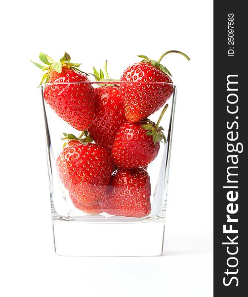 Few strawberries in glass cup isolated on white