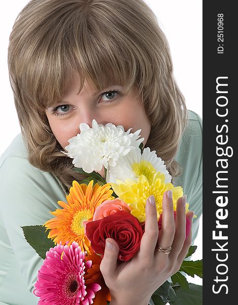 The girl looks atop of a beautiful bouquet of flowers. The girl looks atop of a beautiful bouquet of flowers