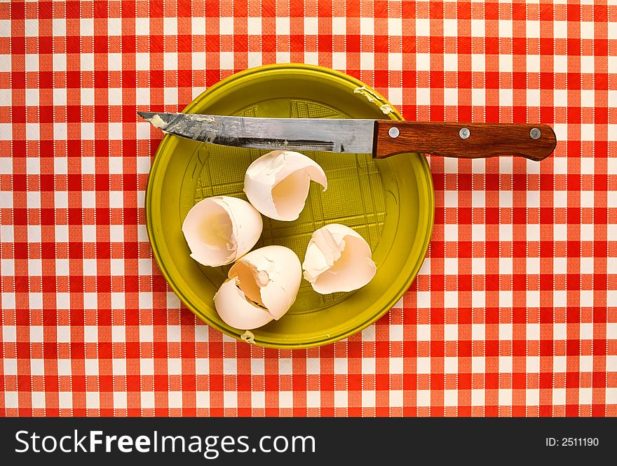 Preparation of  fried eggs,  stayed shell from eggs and  knife on red cloth. Preparation of  fried eggs,  stayed shell from eggs and  knife on red cloth