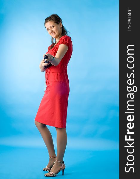 The girl in a red dress on a dark blue background with a umbrella. The girl in a red dress on a dark blue background with a umbrella