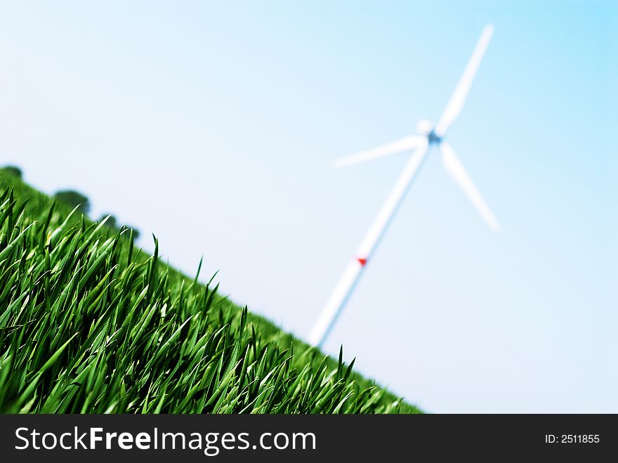 Wind turbine in a green wheat field