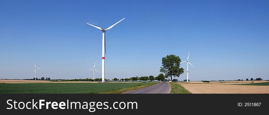 Wind turbine in a green wheat field