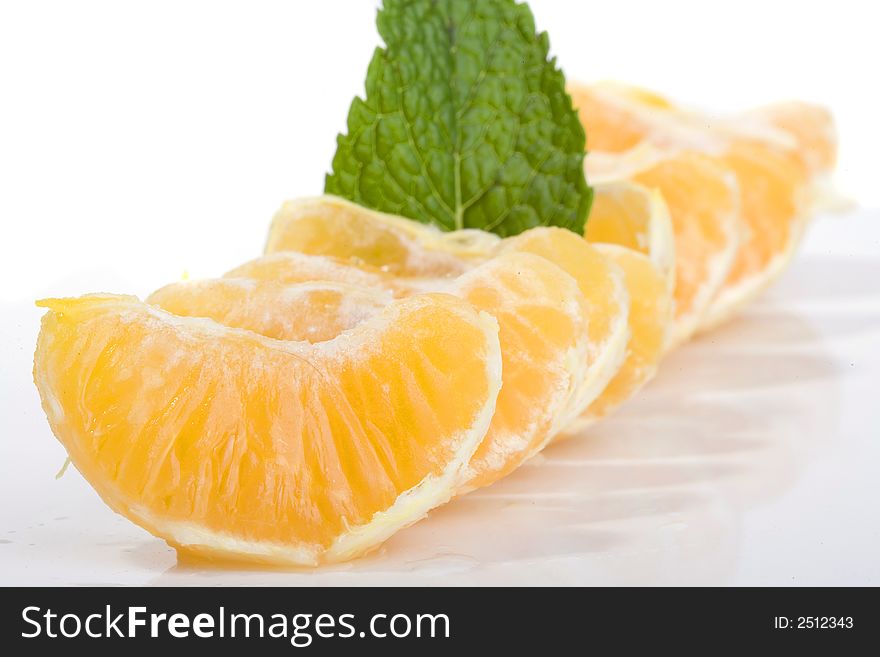 Slices of mandarin fruit and mint leaf. Slices of mandarin fruit and mint leaf