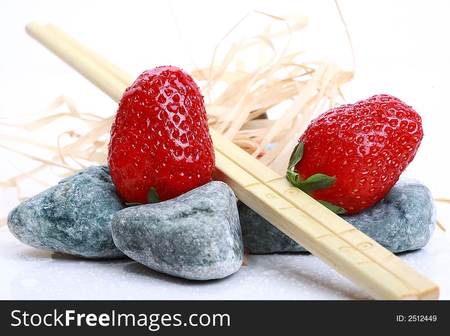 Two strawberry on grey stone with abstract decoration