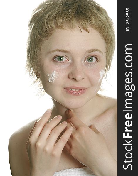 Girl applying creme on her face with hand. Girl applying creme on her face with hand