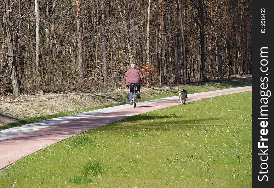 Dog is running with the bike. Dog is running with the bike