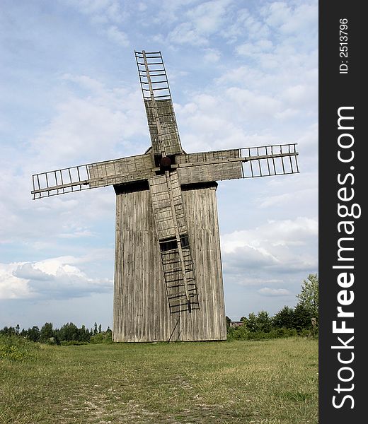 Huge moving windmill in front of clear blue sky