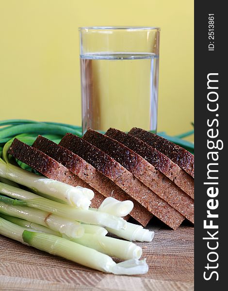 Black bread, onion and glass of water. Black bread, onion and glass of water