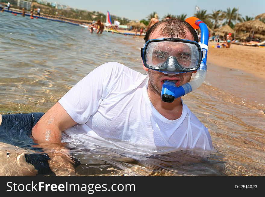 Man with snorkel in mouth in sea