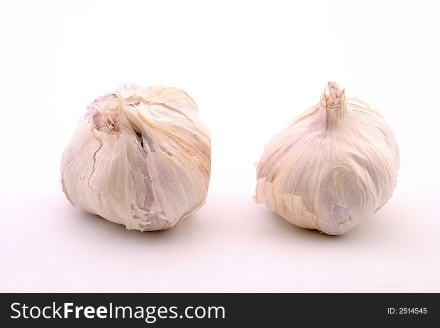 Two garlic bulbs, isolated on white <a href= See more food pictures.</a>