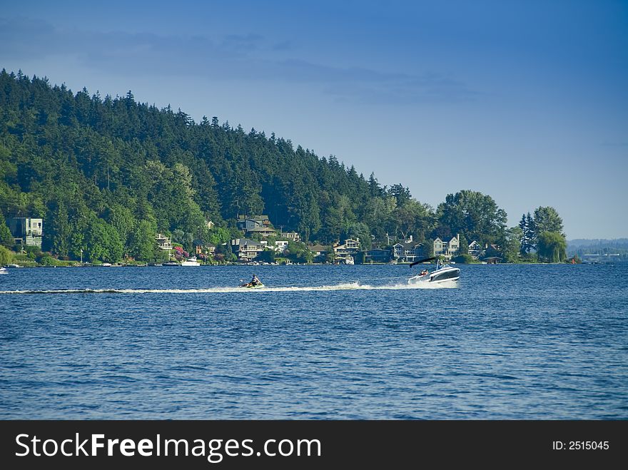 Cobalt ski boat towing a buddy on an inner tube on Lake Washington near Seattle, WA. Cobalt ski boat towing a buddy on an inner tube on Lake Washington near Seattle, WA