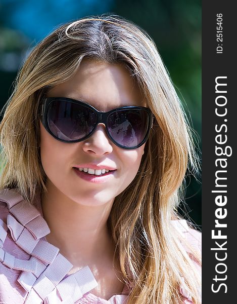 Image shows a pretty girl with sunglasses