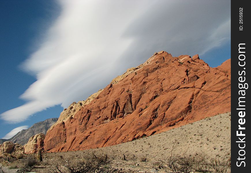 Incredible clouds above a fiery red rock. Incredible clouds above a fiery red rock
