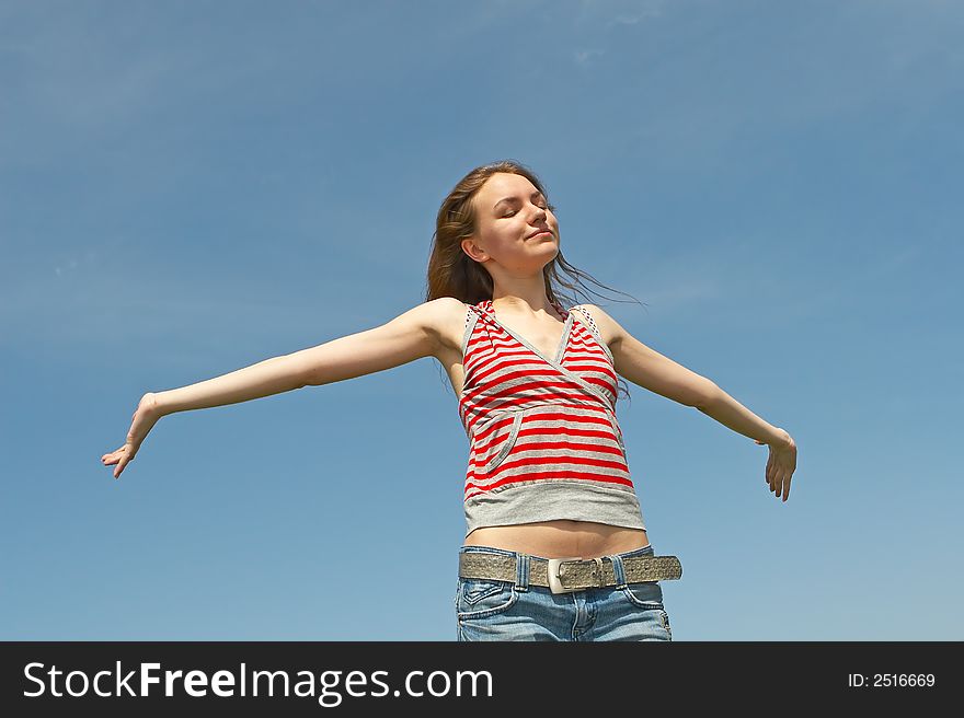 Pretty young girl on a background of the blue sky. Pretty young girl on a background of the blue sky