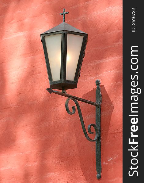 Church lantern on red wall