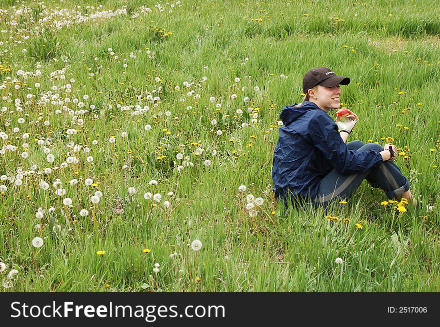 Young sporty woman  during picnic on green meadows outdoors