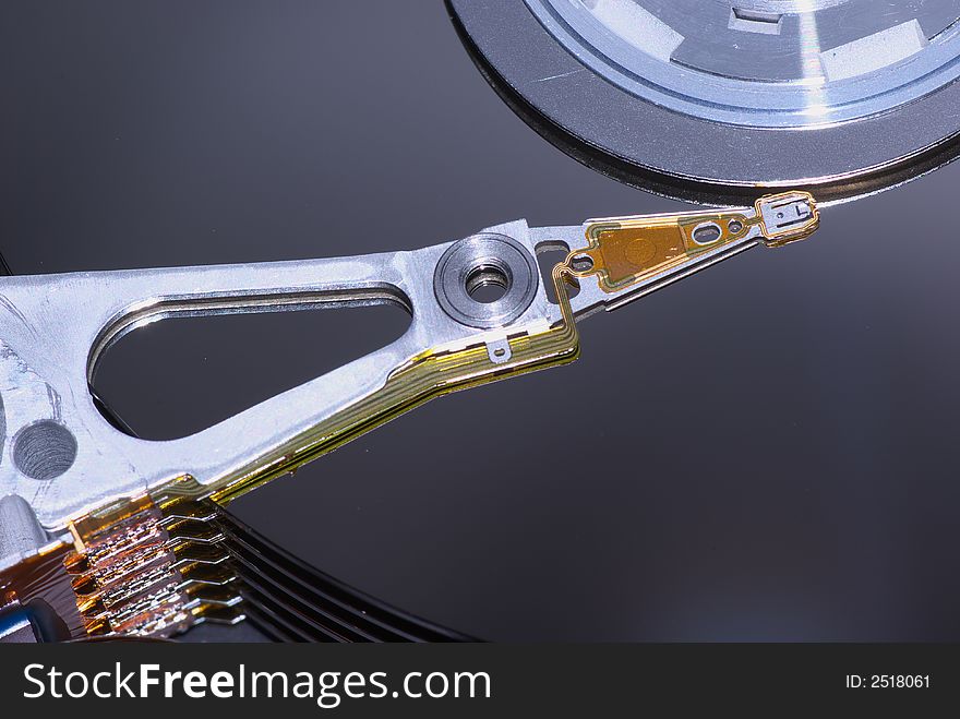 Macro shot of the actuator arm and the platters of  a modern hard disk drive. Macro shot of the actuator arm and the platters of  a modern hard disk drive