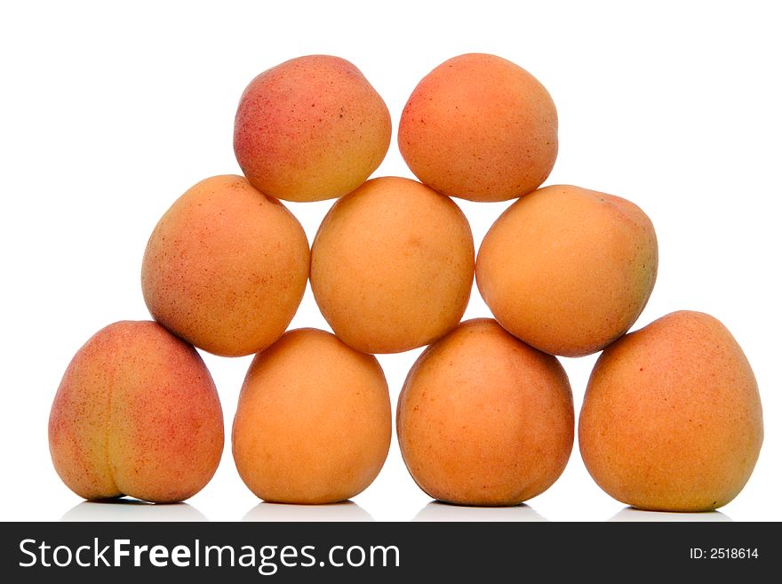 Piled apricots over white background