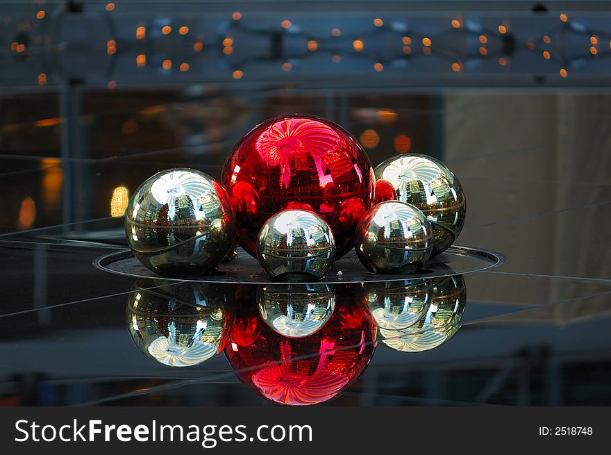 Red and silver christmas decoration balls in reflecting environment in the evening. Red and silver christmas decoration balls in reflecting environment in the evening