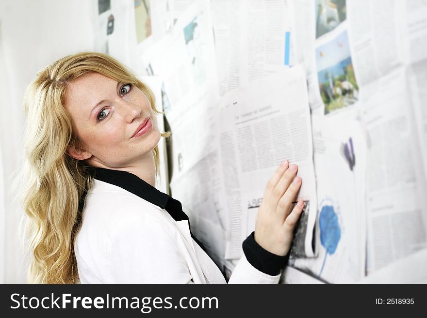 Portrait of a fresh and beautiful blond woman with a lot of newspapers. Portrait of a fresh and beautiful blond woman with a lot of newspapers