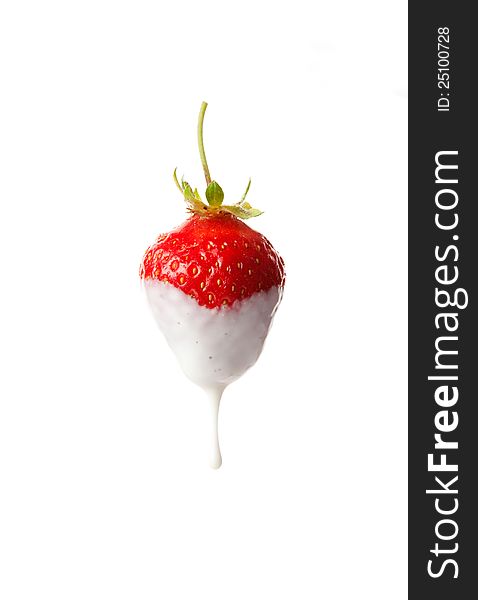 Sweet ripe strawberries with a drop of milk on a white background