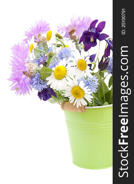 Bucket with wild flowers on a white background