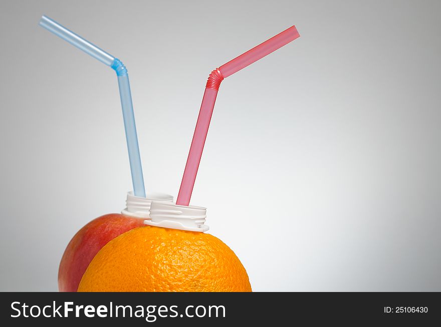 Fresh orange and apple with drinking straw. Fresh orange and apple with drinking straw