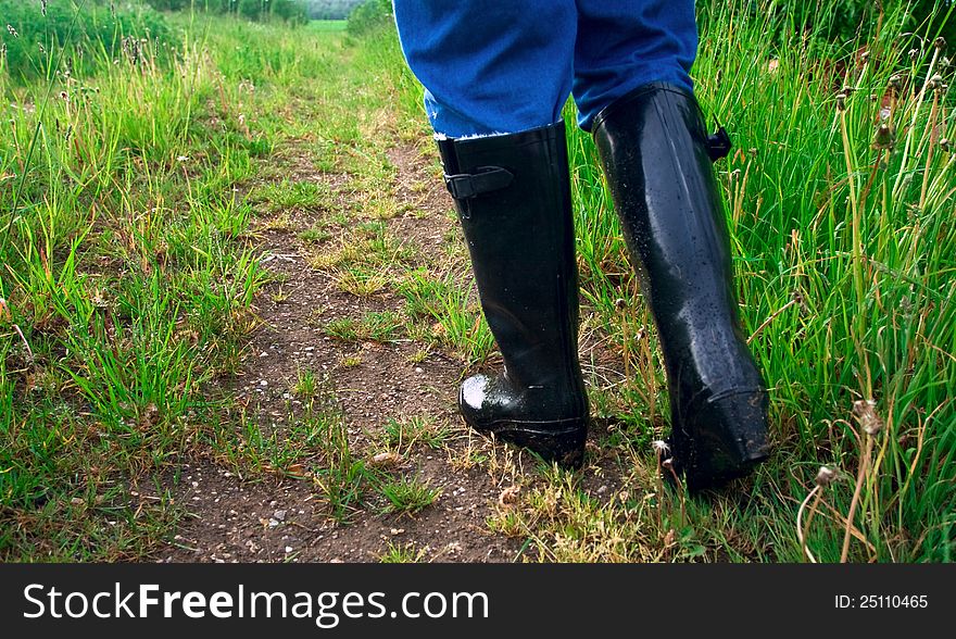 Rubber boots on a wet way