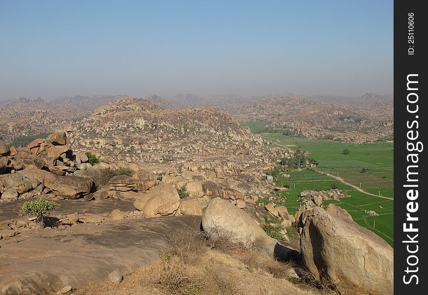 Rice fields and granite mountains near Hampi, India.