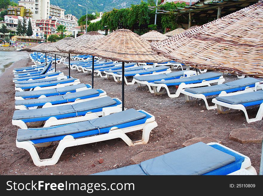 Rows of blue beach chairs on the shore. Rows of blue beach chairs on the shore