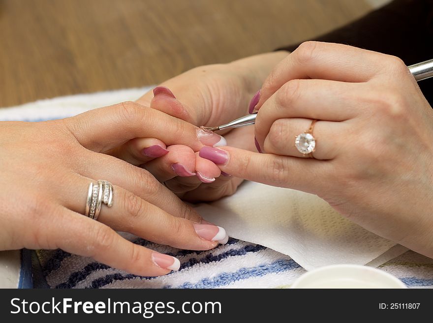 Applying gel at nail during professional manicure