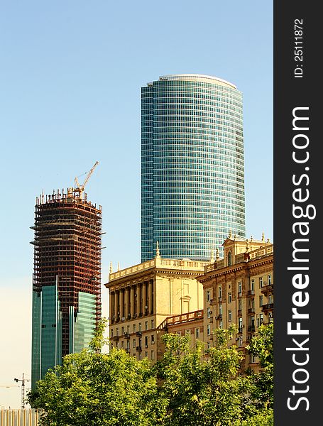 Monumental building of Stalin's style on the  background a of high-tech buildings construction. Monumental building of Stalin's style on the  background a of high-tech buildings construction