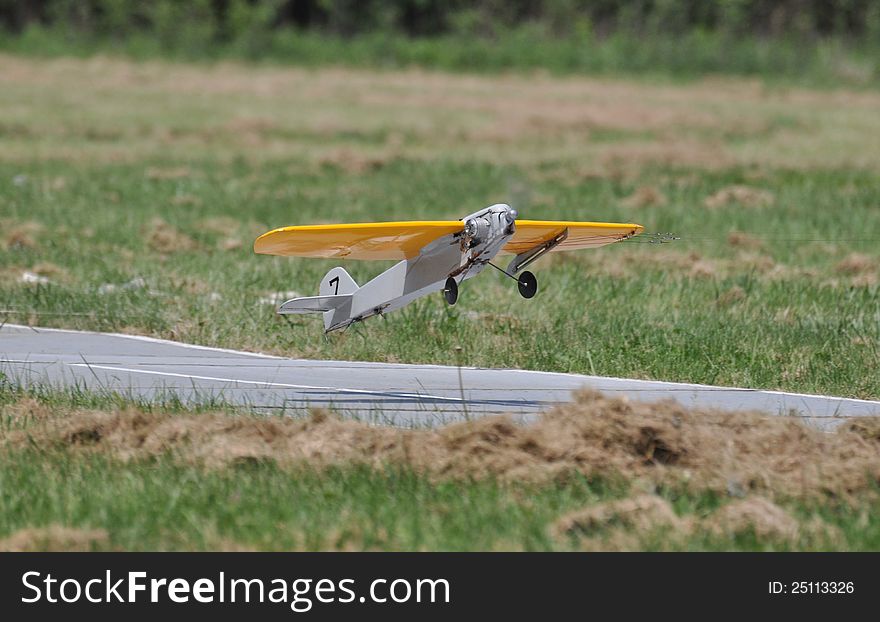 Yellow Model Plane Taking Off from Runway. Yellow Model Plane Taking Off from Runway