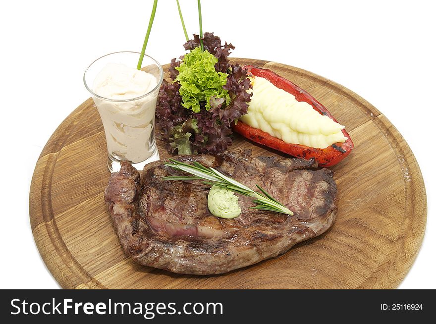 Steak sauce and greens on a white background