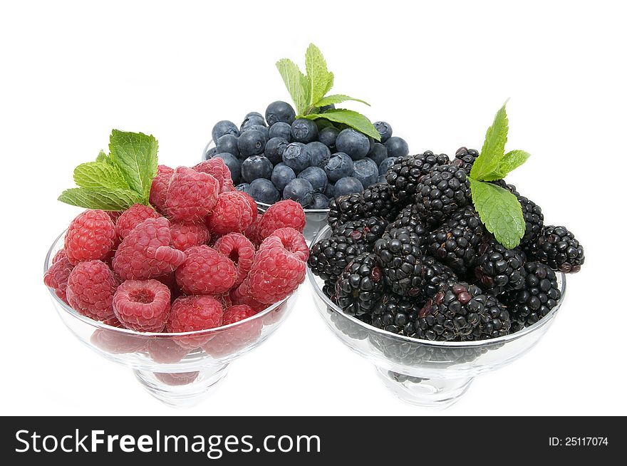 Blueberries raspberries and blackberries on a white background in the restaurant