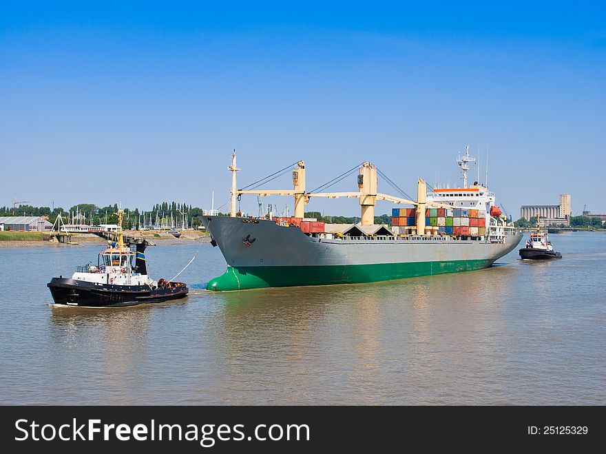 Cargo Ship With two Tugboat