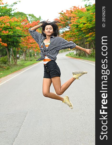 An asian attractive delight girl travelling by thump up with casual wear on blur forest background. An asian attractive delight girl travelling by thump up with casual wear on blur forest background