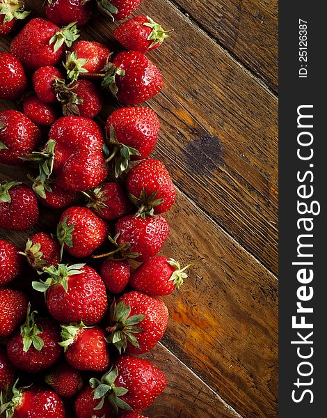 Ripe, juicy, red strawberries on wooden background. Food Frame Background