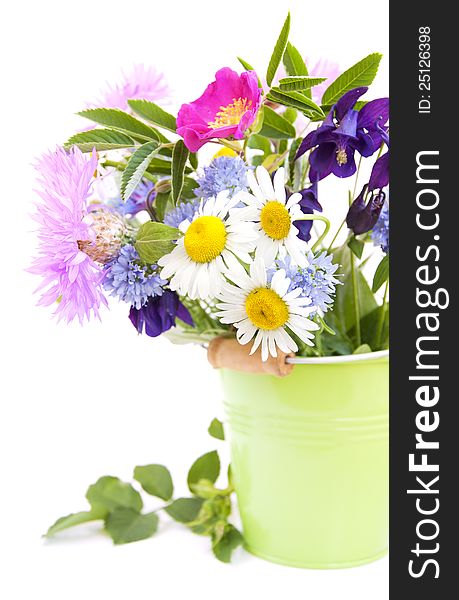 Bucket with wild flowers on a white background