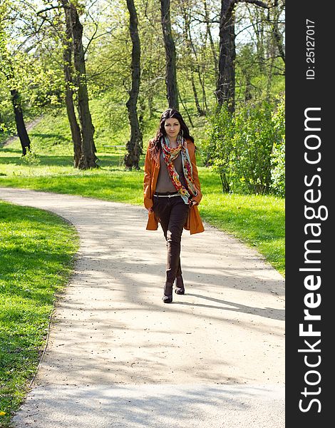 Young woman walking in a spring park. Young woman walking in a spring park