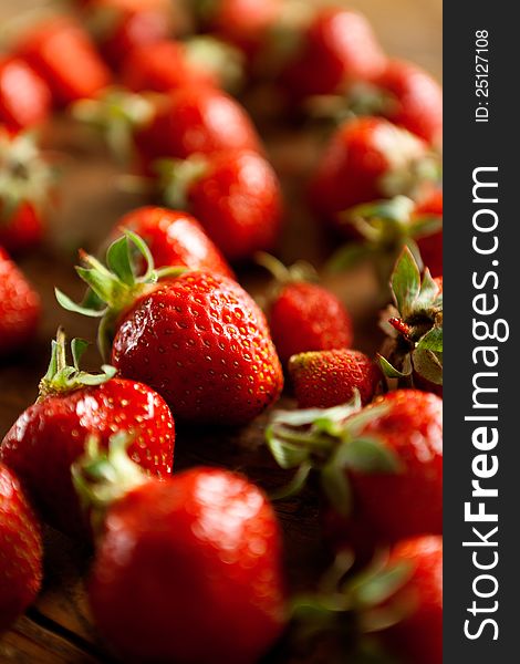 Ripe, juicy, red strawberries on wooden background. Food Frame Background